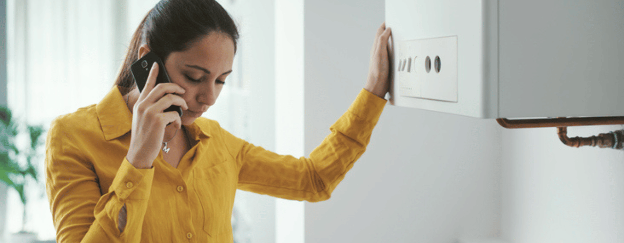 Woman calling for emergency gas boiler repair in Surrey.